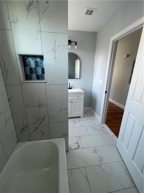 bathroom with vanity and tiled shower / bath combo