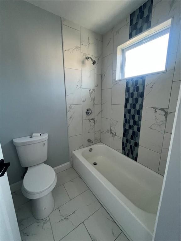 bathroom with tiled shower / bath and toilet