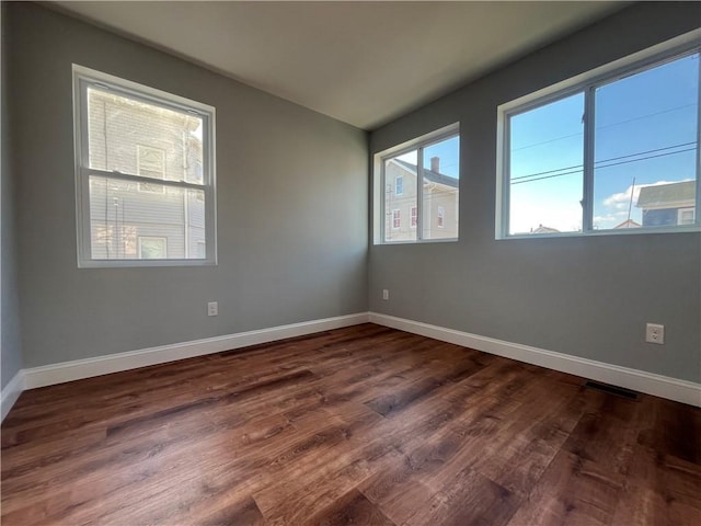 unfurnished room featuring dark wood-type flooring