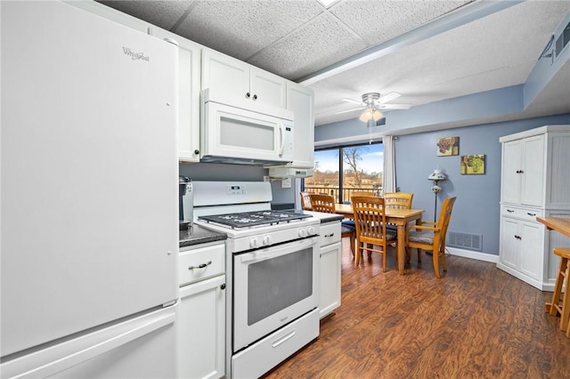 kitchen with white cabinetry, white appliances, dark hardwood / wood-style floors, and ceiling fan