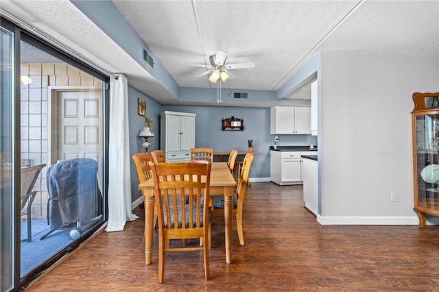 dining room featuring a textured ceiling, a wealth of natural light, dark hardwood / wood-style floors, and ceiling fan