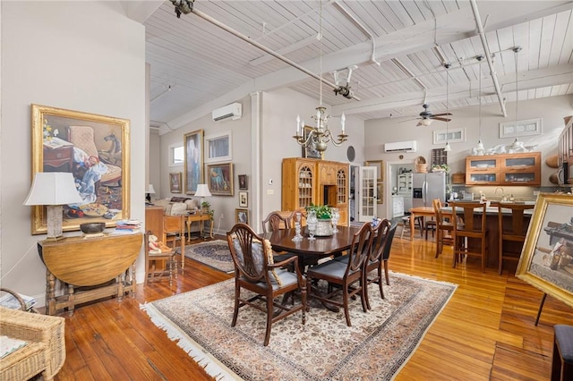 dining room with wood ceiling, a wall unit AC, beamed ceiling, and light wood-type flooring