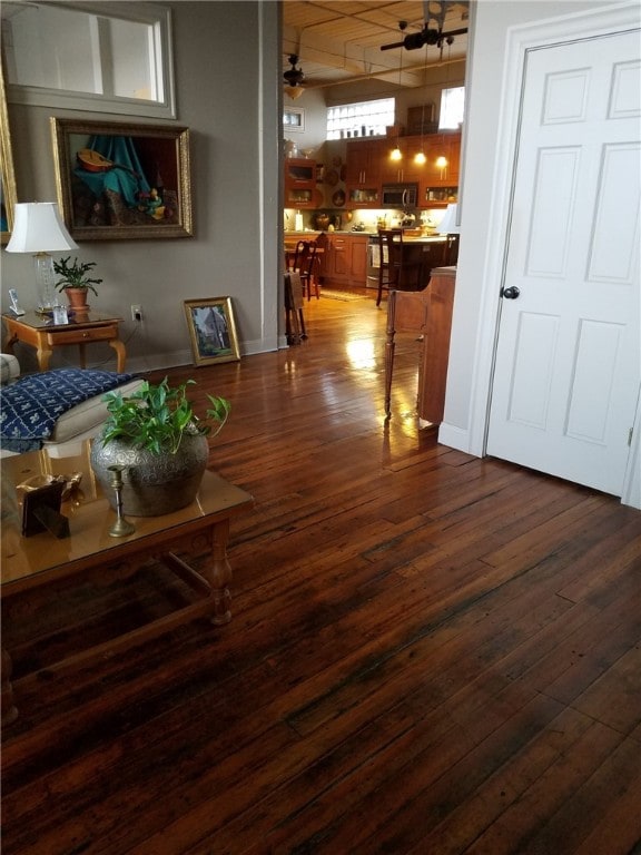 living room with ceiling fan and hardwood / wood-style floors