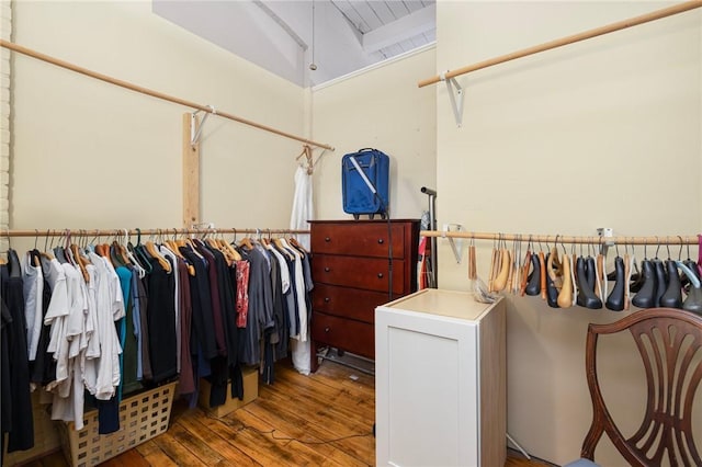 walk in closet featuring vaulted ceiling with beams and wood-type flooring