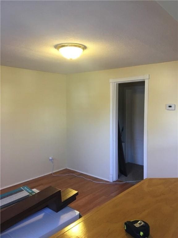 empty room with dark hardwood / wood-style flooring