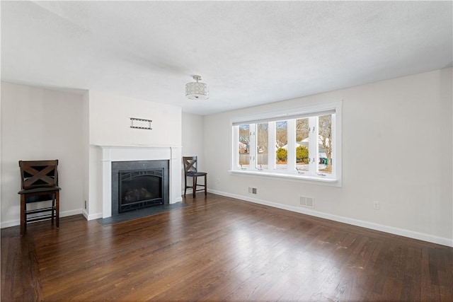 unfurnished living room with dark hardwood / wood-style floors