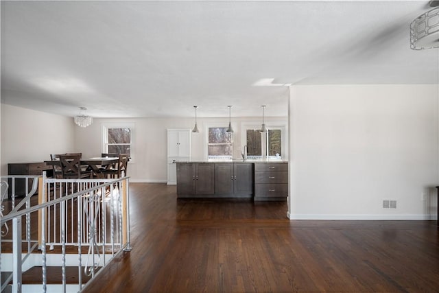 interior space with a notable chandelier and dark hardwood / wood-style floors