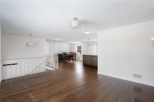 unfurnished living room with dark hardwood / wood-style flooring