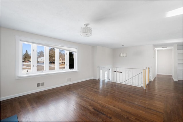 spare room featuring dark hardwood / wood-style floors