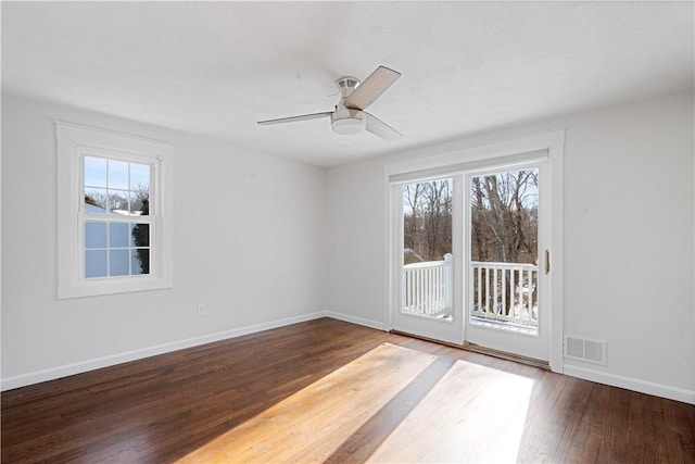 spare room with ceiling fan, wood-type flooring, and a wealth of natural light