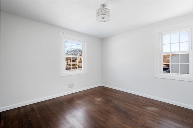 spare room featuring wood-type flooring