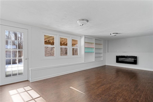 unfurnished living room with hardwood / wood-style flooring