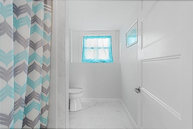 bathroom featuring toilet and a shower with shower curtain