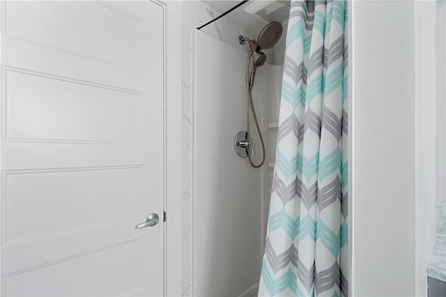 interior details featuring a shower with shower curtain