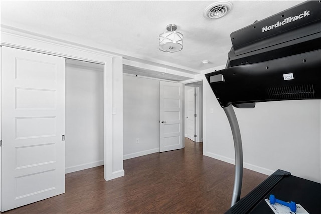 exercise room featuring dark hardwood / wood-style floors