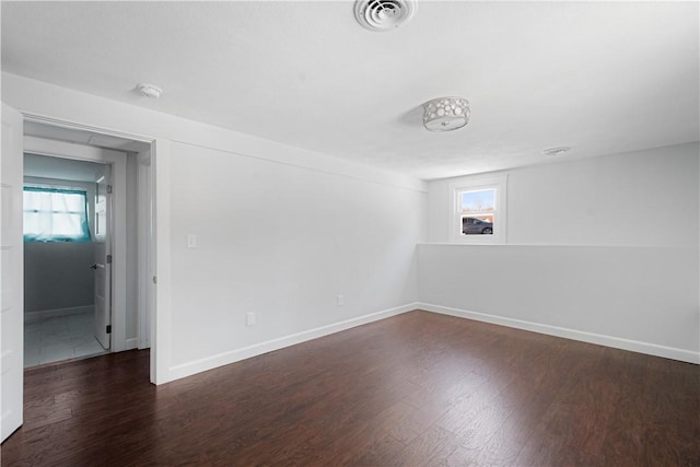 unfurnished room with dark hardwood / wood-style flooring