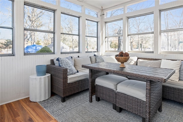 sunroom featuring breakfast area and a healthy amount of sunlight