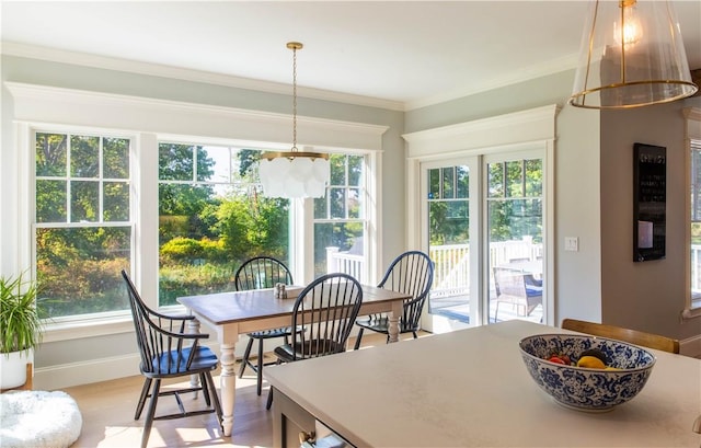 dining area featuring wood-type flooring and ornamental molding