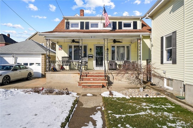 view of front of house featuring a porch, a garage, and ceiling fan