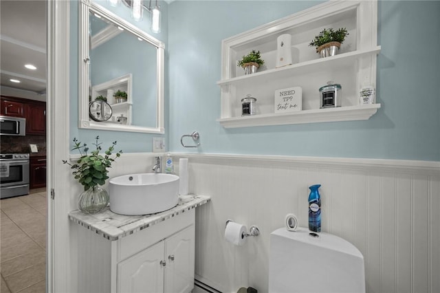 bathroom featuring vanity, tile patterned floors, and toilet