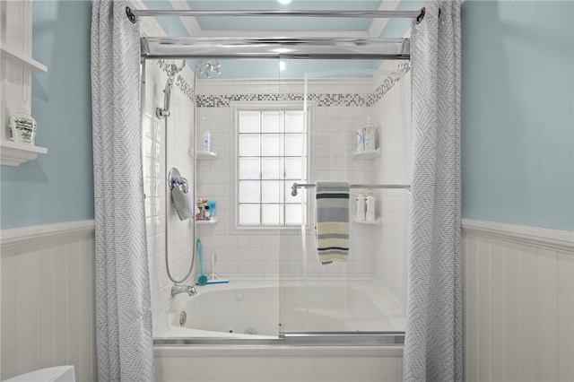 bathroom with bath / shower combo with glass door