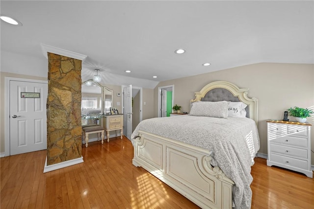 bedroom featuring light hardwood / wood-style flooring and vaulted ceiling