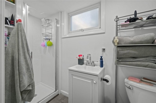 bathroom featuring an enclosed shower, vanity, and toilet