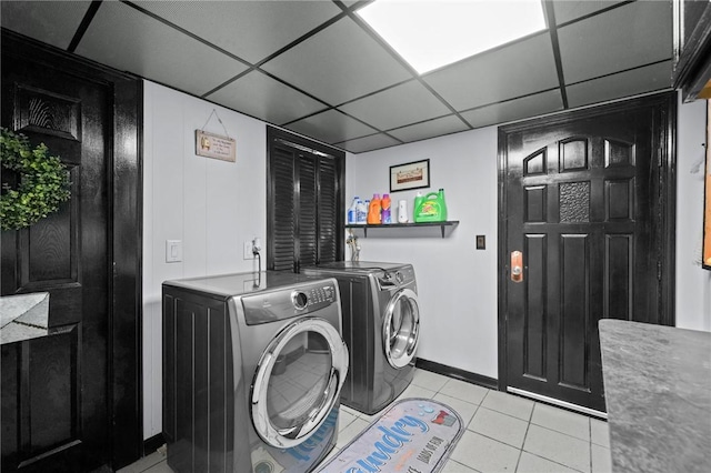 laundry room with light tile patterned flooring and washing machine and clothes dryer