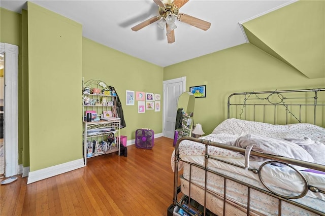 bedroom with wood-type flooring, ceiling fan, and vaulted ceiling