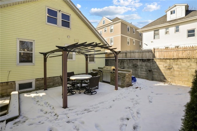 snow covered house featuring a pergola