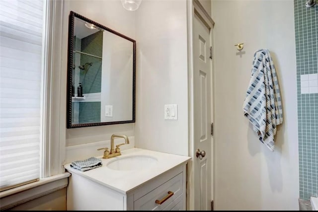 bathroom with vanity and a shower