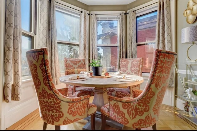 dining space featuring a wealth of natural light and light parquet floors