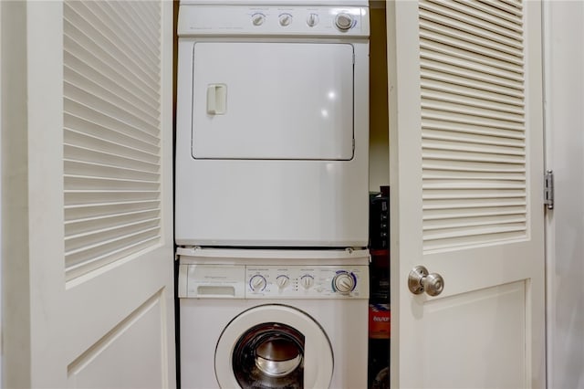 clothes washing area featuring stacked washing maching and dryer