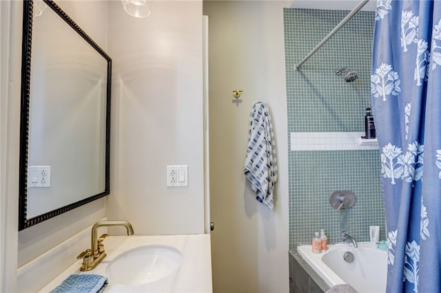 bathroom featuring vanity and shower / bathtub combination with curtain