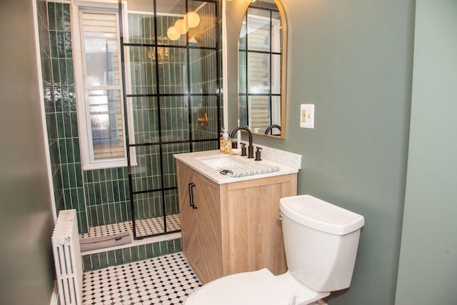 bathroom with vanity, radiator, and toilet