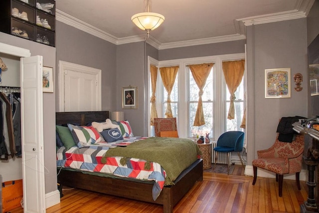 bedroom featuring hardwood / wood-style floors and ornamental molding