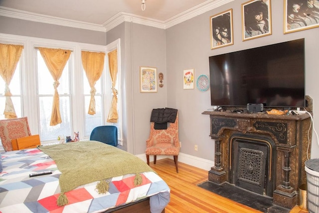 bedroom featuring ornamental molding and hardwood / wood-style floors