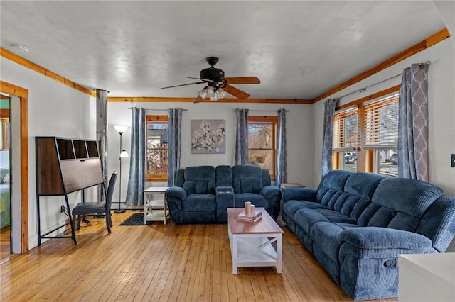 living room with crown molding, ceiling fan, and light hardwood / wood-style flooring