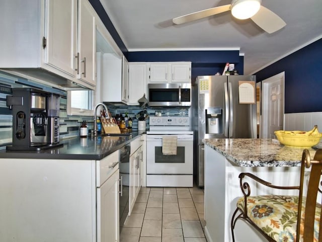 kitchen featuring sink, light tile patterned floors, white cabinetry, stainless steel appliances, and decorative backsplash