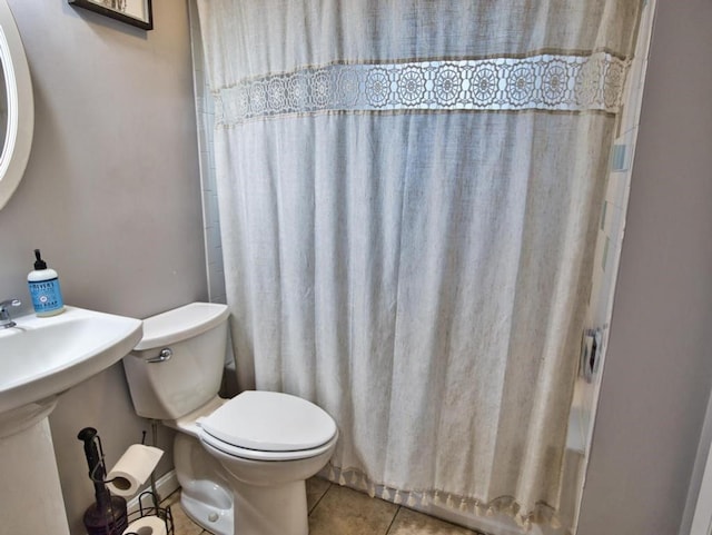 bathroom with tile patterned floors and toilet