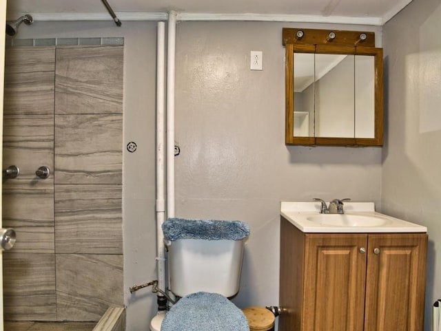 bathroom featuring tiled shower, vanity, and toilet