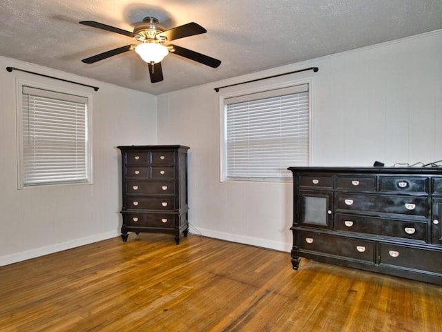 interior space with ceiling fan, hardwood / wood-style floors, and a textured ceiling