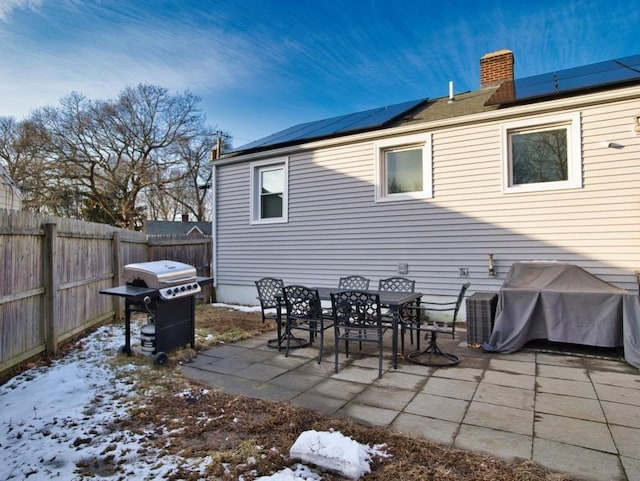 snow covered patio featuring grilling area