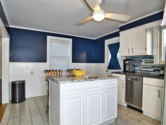 kitchen featuring white cabinetry, crown molding, dishwasher, a kitchen island, and ceiling fan