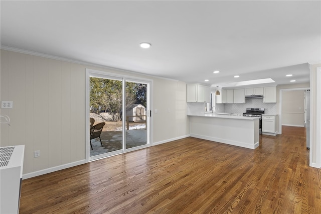 kitchen with white cabinetry, stainless steel range oven, dark hardwood / wood-style flooring, decorative backsplash, and kitchen peninsula