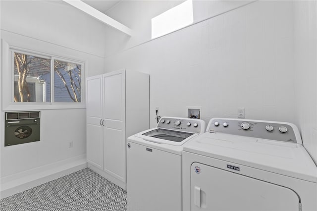 laundry room with washer and clothes dryer and light tile patterned flooring