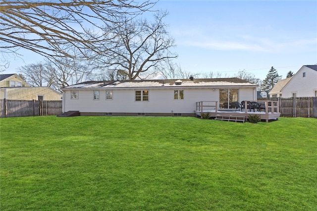 rear view of house with a wooden deck and a yard