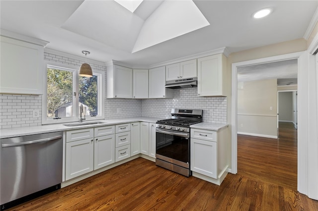 kitchen featuring pendant lighting, appliances with stainless steel finishes, sink, and white cabinets