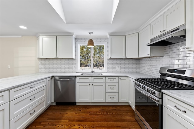 kitchen with sink, decorative light fixtures, white cabinets, and appliances with stainless steel finishes