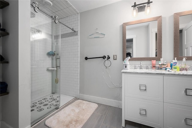 bathroom featuring vanity and a shower with shower door